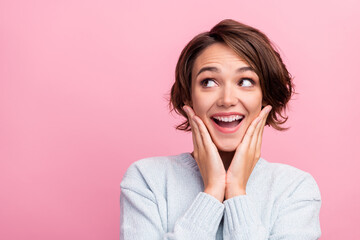 Photo of amazed surprised funny lady hands cheeks look empty space wear blue pullover isolated pink color background