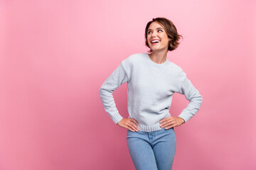 Photo of dreamy pretty lady hands hips look empty space wear blue sweater isolated pink color...