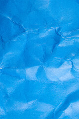Crumpled blue paper background.