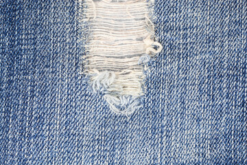 Torn denim jeans texture. - obrazy, fototapety, plakaty