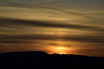 Sun disc in the clouds at sunset