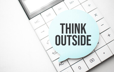 speech bubble with text Think Outside and calculator in the white background