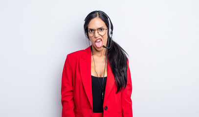 pretty hispanic woman feeling disgusted and irritated and tongue out. telemarketing concept