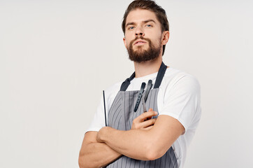 man in apron scissors comb provision of services