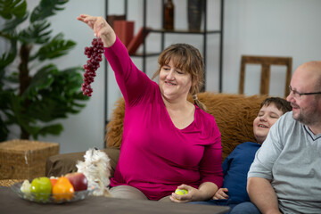 The wife shows the grapes to the dog and the whole family rejoices.