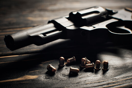 Revolver pistol with Flobert ammo 4mm on dark wooden background