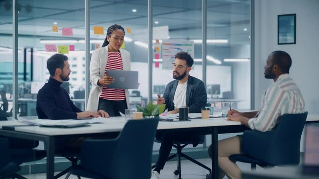 Diverse Modern Office: Successful Motivated Black Businesswoman Leads Meeting, talks of Company Growth. Digital Entrepreneurs Work on e-Commerce Project. Multi-Ethnic Creatives Brainstorm Strategy