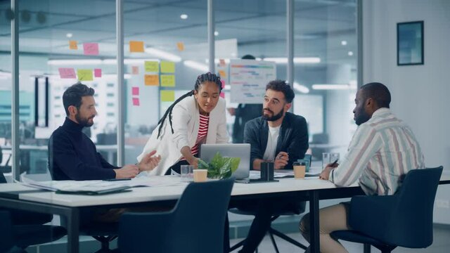 Diverse Modern Office: Successful Motivated Black Businesswoman Leads Meeting, talks of Company Growth. Digital Entrepreneurs Work on e-Commerce Project. Multi-Ethnic People Brainstorming. Slow Motion