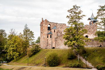 Fototapeta na wymiar Beautiful ruined castle in the city park. Local landmark (1089)