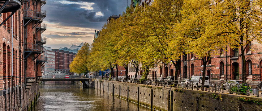 tree-lined canal and historic buildings in old warehouse district Speicherstadt in Hamburg, Germany