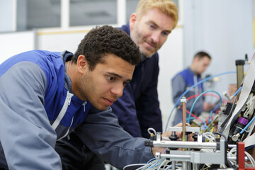 young electrical engineer inspecting wire