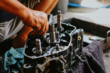 Fototapeta na wymiar Maintenance of motorcycle engine clutch system by technicians