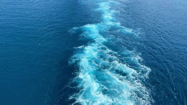 A Cruise ship wake on a beautiful turquoise and blue seas