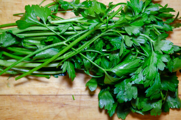 green parsley bundle on a wooden cutting board herb close up macro