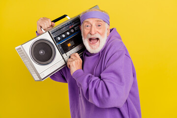 Profile side photo of excited mature man male louder music boombox song isolated over yellow color background © deagreez