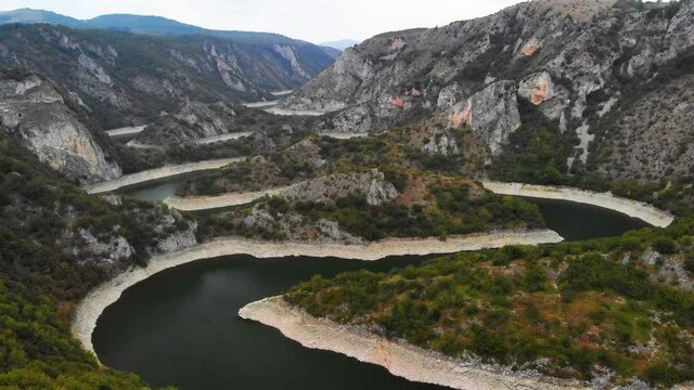 Aerial view meanders of river Uvac. Flying over the beautiful river and mountain, sunny day. Aerial drone shot, landscape panorama. River and lake Uvac in Serbia