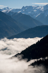 wonderful view in the morning with fog in the valley and blue sky on the mountains
