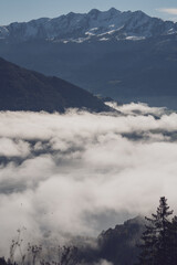 wonderful view in the morning with fog in the valley and blue sky on the mountains