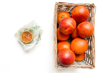 Basket of blood oranges and half-blood orange in beeswax food wrap. Fabric bee wrap to keep food...