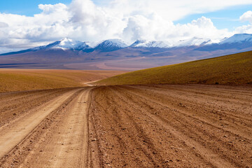 Desert view in Bolivia with snow capped volcano's in the background