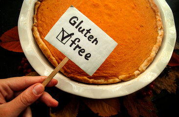 Photo of gluten free pumpkin pie. Autumn decor. Traditional Thanksgiving food. 