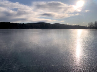 Sun over frozen lake