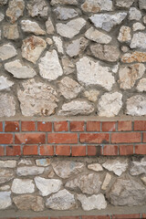 Old brick wall, old texture of red stone blocks closeup