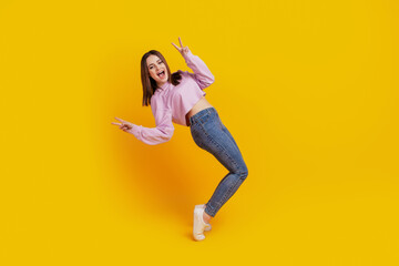 Fototapeta na wymiar Full size profile side photo of young excited girl have fun show peace cool v-sign isolated over yellow color background