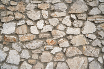 Old brick wall, old texture of red stone blocks closeup