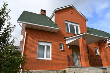 Fototapeta na wymiar Private residential building in Russia made of red brick.