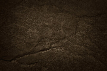 Dark brown slate stone wall texture background in natural pattern for decorative interior and exterior.