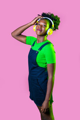 young black woman looking over listening music wireless headphones smiling happy and serene