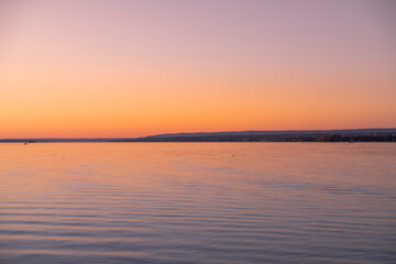 Fototapeta premium Beautiful sunrise reflecting on calm water