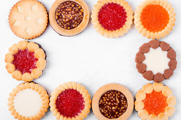 Cookies framing copy space on the white table. Flat lay. Food background