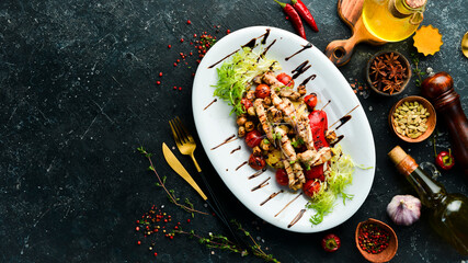 Healthy food. Chicken breast with grilled vegetables on a white plate. Top view.