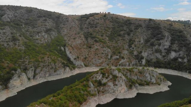 Aerial view meanders of river Uvac. Flying over the beautiful river and mountain, sunny day. Aerial drone shot, landscape panorama. River and lake Uvac in Serbia