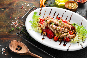 Healthy food. Chicken breast with grilled vegetables on a white plate. Top view.