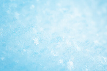 Snowy background with closeup view of the crystal snowflakes