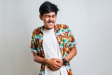 Asian man waring casual shirt diarrhea health problems hold his belly