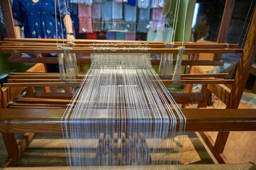 detail of a wooden loom with the threads arranged