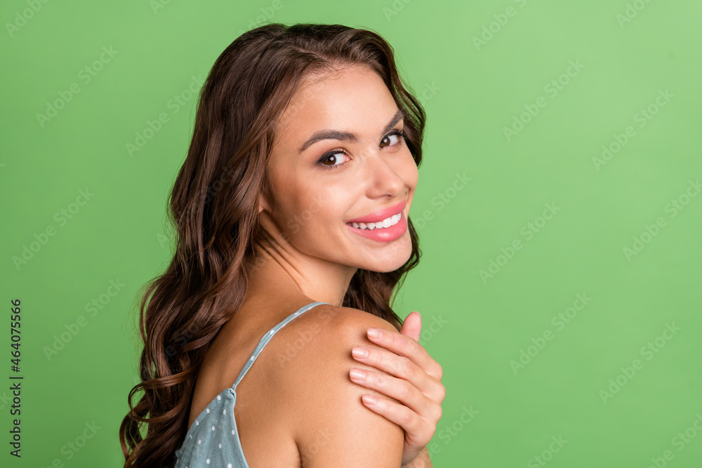 Sticker photo of young positive joyful woman hold hand shoulder bodycare beauty isolated on green color back