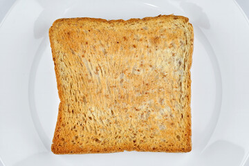 flat lay top view of golden crunchy toasted sliced whole wheat sandwich bread isolated on white...