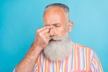 Fototapeta premium Photo of tired ill pensioner man fingers nose bridge suffer headache wear striped shirt isolated blue color background