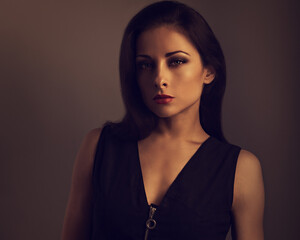 Beautiful makeup  woman with red lipstick and  volume brown long hair looking serious. Closeup...