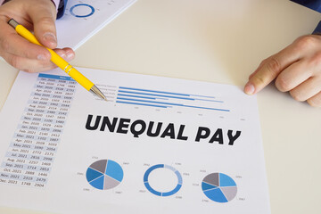 Business concept about UNEQUAL PAY with sign on the chart sheet.