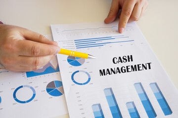 Business concept about CASH MANAGEMENT with phrase on the printout with diagrams and tables.