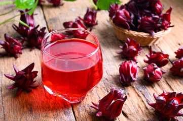 Roselle juice on wooden background, herbal organic tea for good healthy
