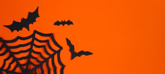 Happy Halloween. Paper bats on orange background.