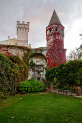 The tower of the old villa Cimbrone (, entwined with red ivy - the beginning of autumn in southern Italy (Campania).