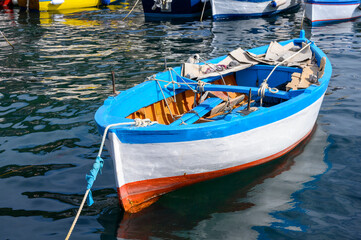 Fototapeta na wymiar horizontal close up detail old boat in cetara amalfi coast italy - harbor boats wood blue red white - relaxed calm - nobody no people